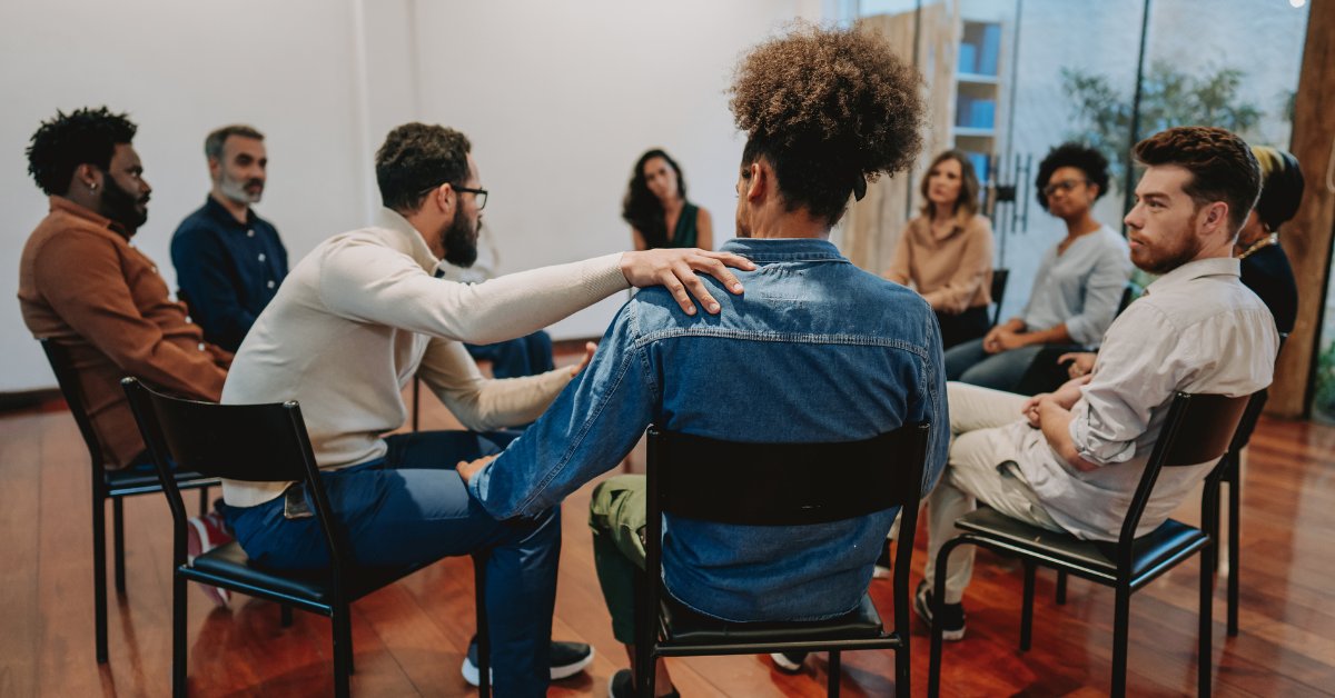 A diverse support group sitting in a circle, representing secular recovery groups and their discussions.