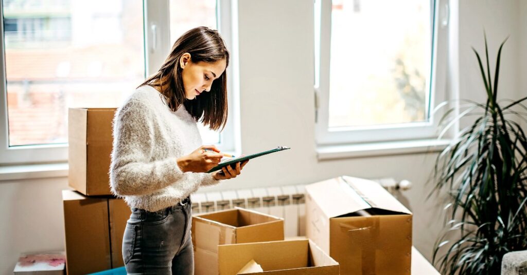 A woman organizing boxes, symbolizing the question: Is it a good idea to move if I'm addicted?